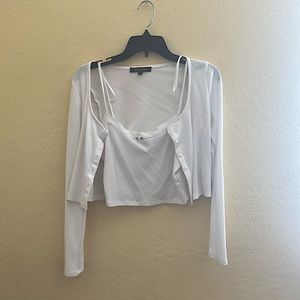 It’s a cute medium white tank top paired with a cropped bottom up sweater